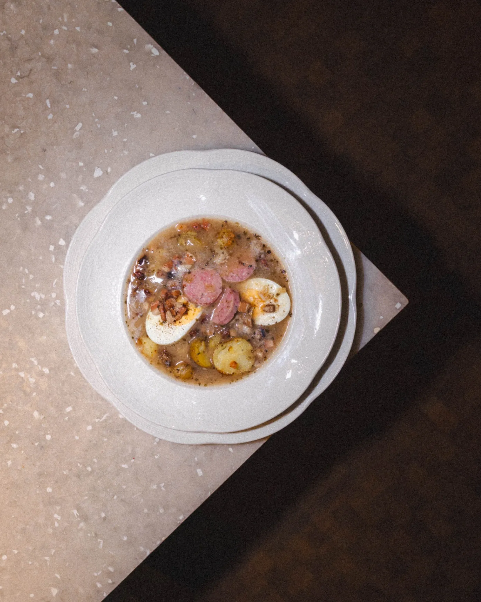 Slow-cooked sour rye soup with sausage, poached egg and potato crisps — chef's signature. 👨‍🍳
